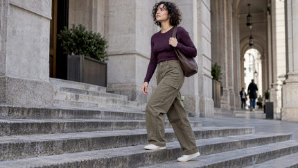 Woman wearing cargo pants and a fitted plum top