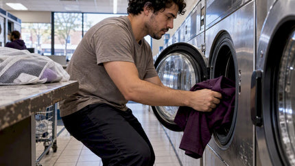 Plum polyester polo being loaded into washer