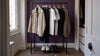 Everyday wardrobe essentials on a clothing rack