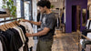 Shopper browsing graphic tees in a clothing store