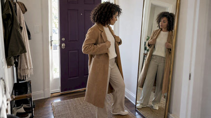 Woman styling a tonal ivory and camel outfit