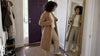 Woman styling a tonal ivory and camel outfit