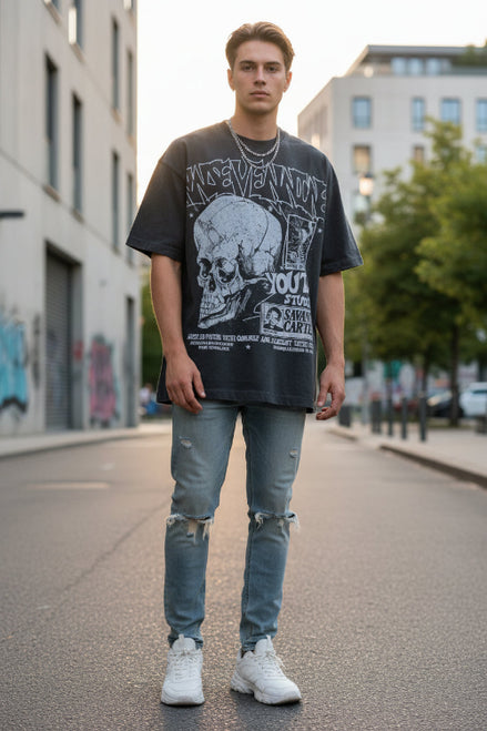 Person wearing a dark gray t-shirt with graphic designs and text.