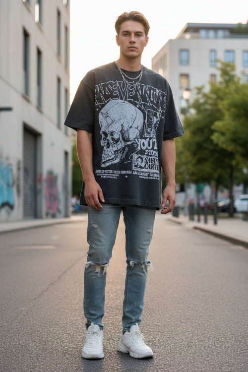Person wearing a dark gray t-shirt with graphic designs and text.