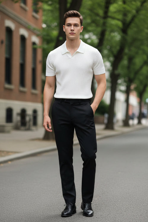 Person wearing a white ribbed knit shirt with glasses on the chest, standing against a neutral background.