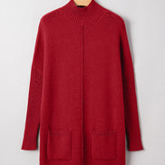 Red sweater dress on a hanger against a white background