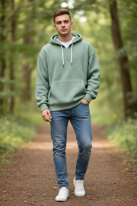 Green fleece pullover with a hood worn by a person on a white background