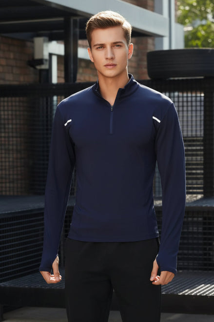 Person wearing a navy long-sleeve athletic shirt with white accents against a dark background