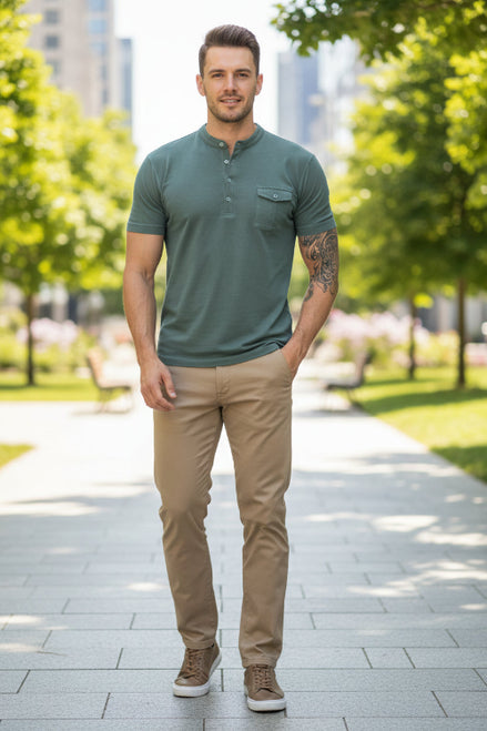 Man wearing a green polo shirt with a pocket on a white background