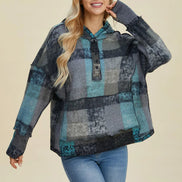 Woman wearing a plaid shirt with a neutral background