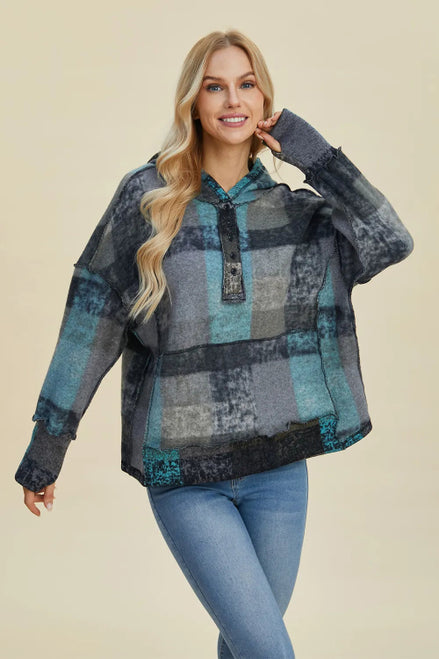 Woman wearing a plaid shirt with a neutral background