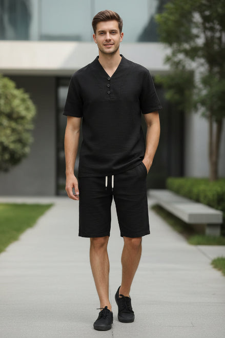 Black outfit with a shirt and pants on hangers against a white background