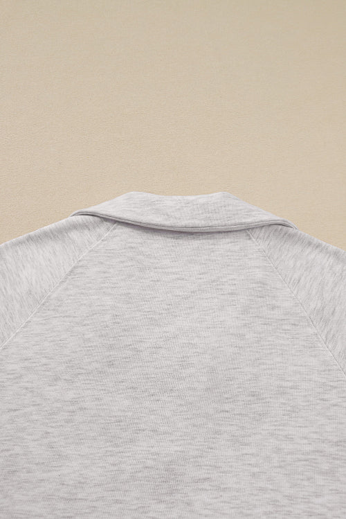 Close-up of a gray textured shirt on a beige background