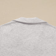 Close-up of a gray textured shirt on a beige background
