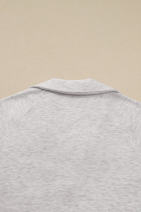 Close-up of a gray textured shirt on a beige background
