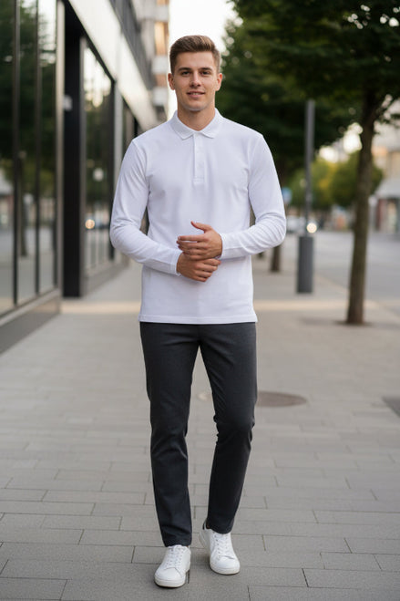 Person wearing a white long-sleeve top with a blurred background