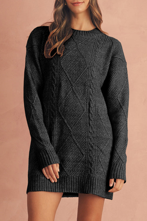 Person wearing a dark gray cable knit sweater dress against a beige background