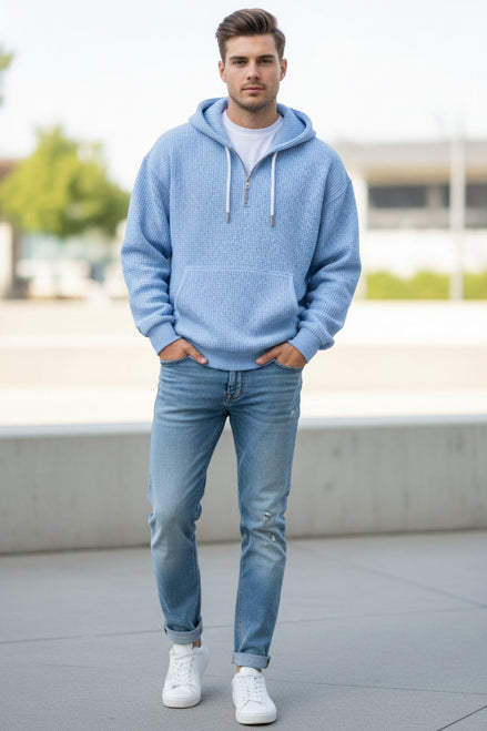 Light blue textured hoodie worn by a person on a white background
