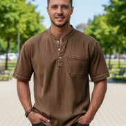 Brown short-sleeve shirt worn by a person on a white background