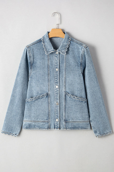 Light blue denim jacket with ruffled collar on a hanger against a white background