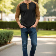 Black long-sleeve shirt with brown sleeves worn by a person on a white background