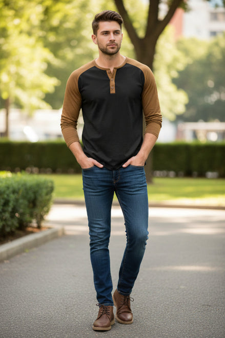 Black long-sleeve shirt with brown sleeves worn by a person on a white background