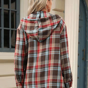 Person wearing a plaid jacket outdoors