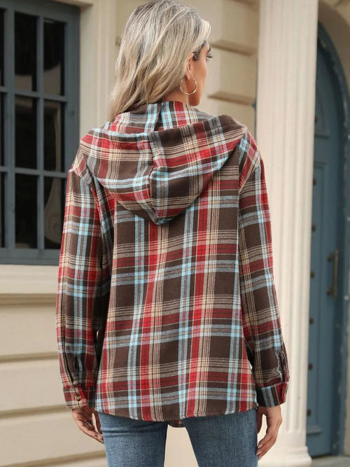 Person wearing a plaid jacket outdoors