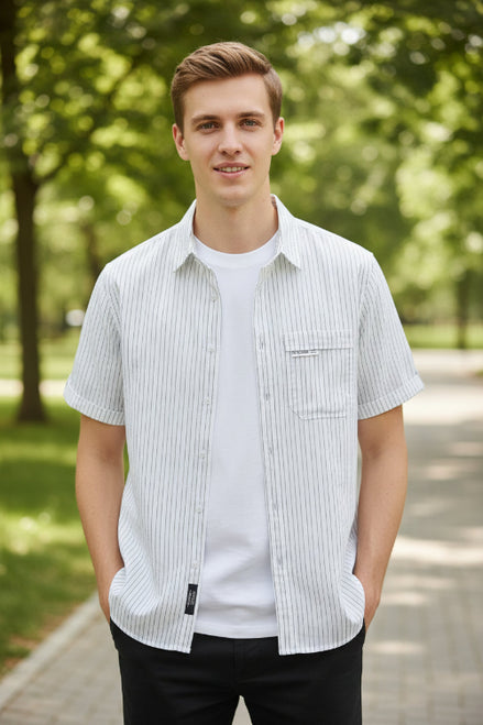White and gray striped short-sleeve shirt on a hanger against a gray background
