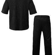 A two-piece black ribbed lounge set consisting of a short-sleeve button-up shirt and matching straight-leg pants, 