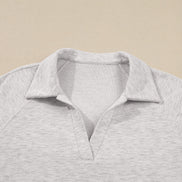 Gray polo shirt on a beige background