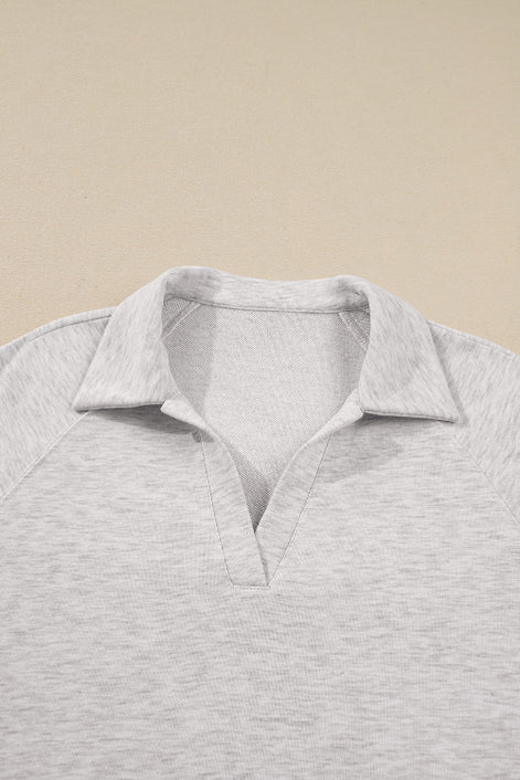 Gray polo shirt on a beige background