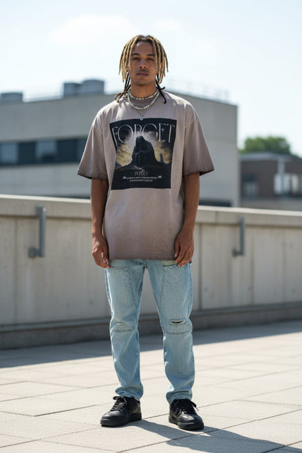 Person wearing a gray t-shirt with a graphic design and text.
