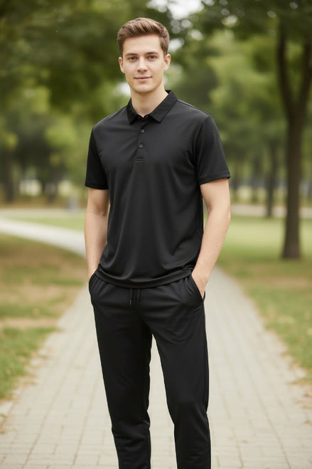 Black polo shirt and pants set on a hanger against a blue background