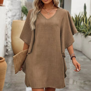 Woman wearing a brown dress with a blurred background