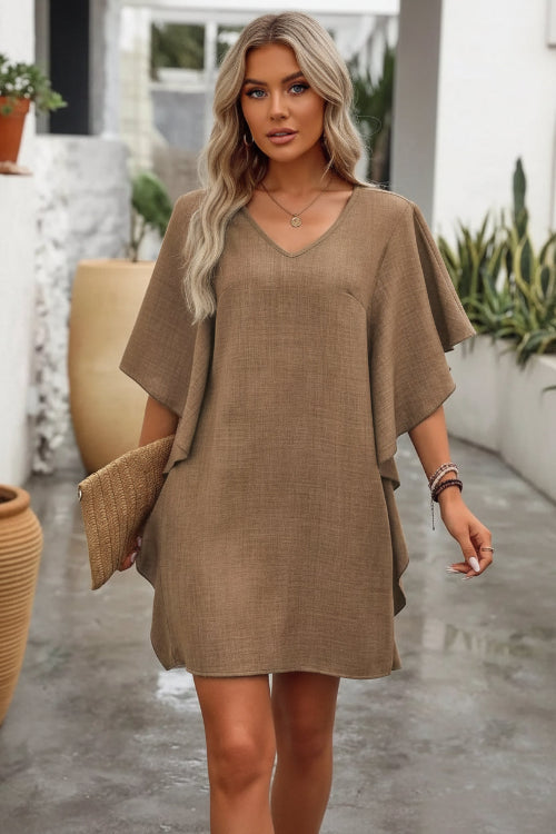 Woman wearing a brown dress with a blurred background