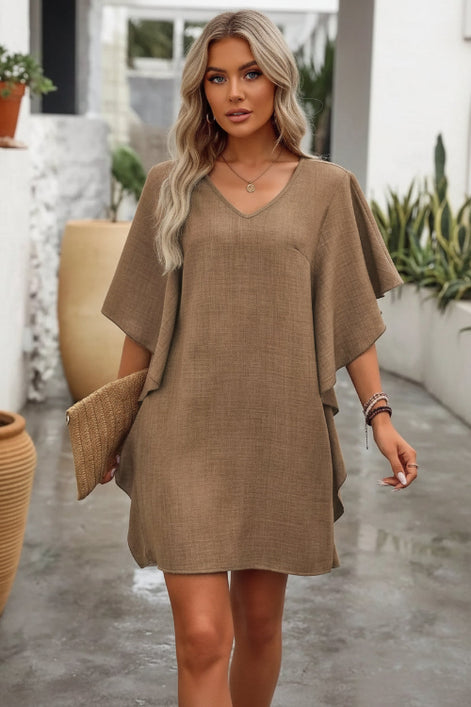 Woman wearing a brown dress with a blurred background
