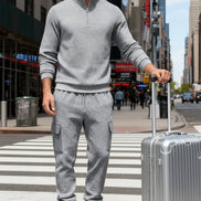 A man wearing a matching gray waffle-knit quarter-zip pullover and cargo jogger set 