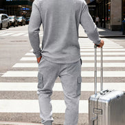 A man wearing a light gray waffle-knit matching lounge set, 