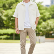 Beige cardigan over a white shirt on a white background