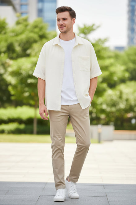 Beige cardigan over a white shirt on a white background