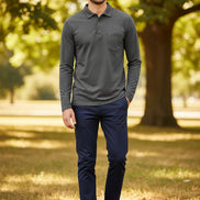 Man wearing a gray long-sleeve shirt with a pocket on a white background