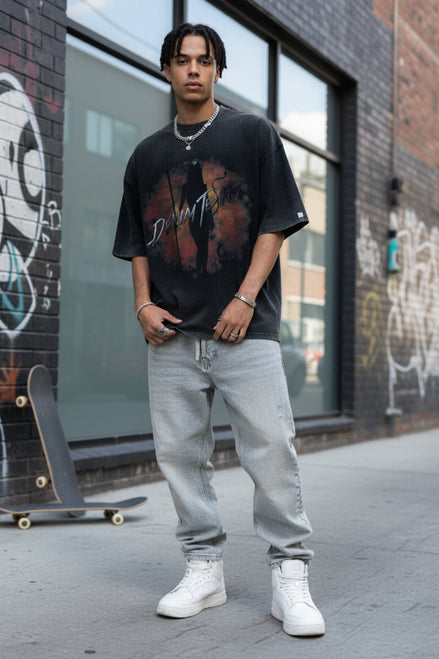 Person wearing a black t-shirt with a graphic design and text.