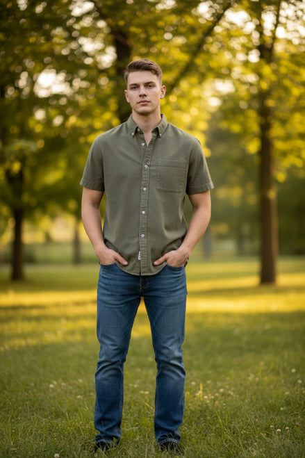 Man wearing a beige short-sleeve shirt with a collar on a light gray background