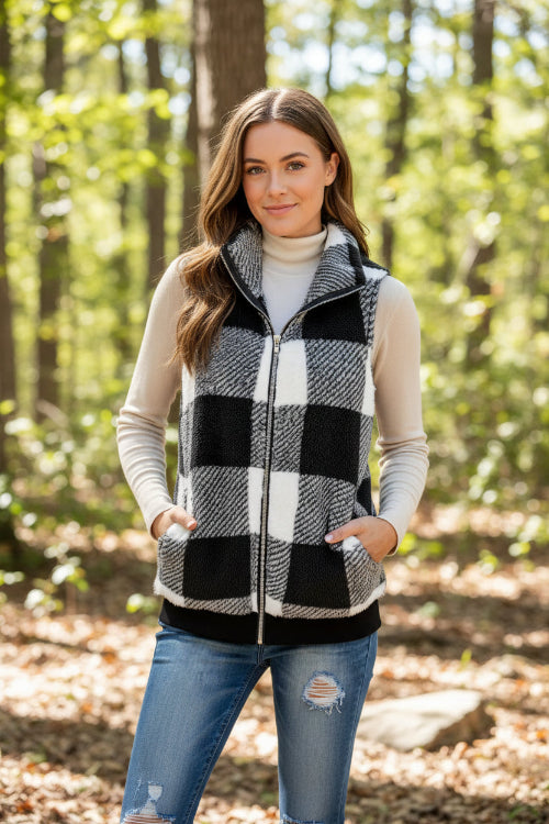 Person wearing a black and white checkered vest with a neutral background
