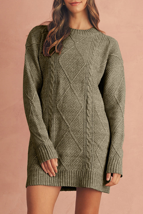 Person wearing a green cable knit sweater against a beige background