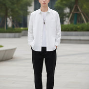 White button-up shirt worn by a person on a gray background