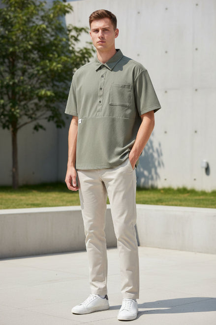 Green short-sleeve shirt with collar and front pocket on a white background