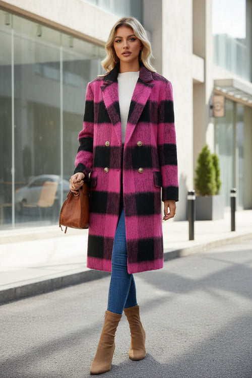Woman wearing a pink and black checkered coat with a brown bag and boots on a white background