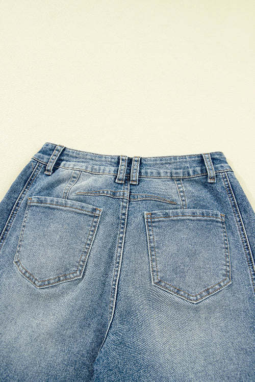 Close-up of a pair of blue jeans on a beige background